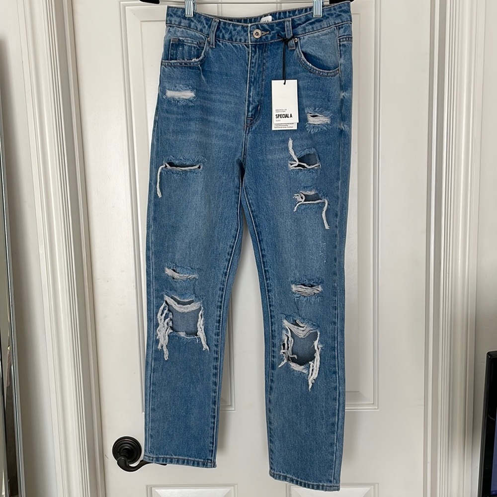 Medium light ripped blue jean